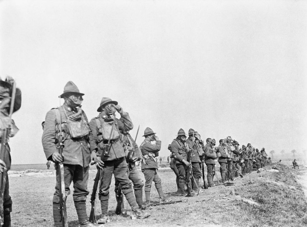 New Zealand soldiers wearing their gas masks during musketry training.